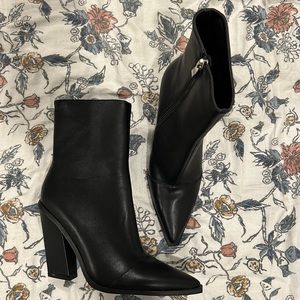 Black pointed toe boots.